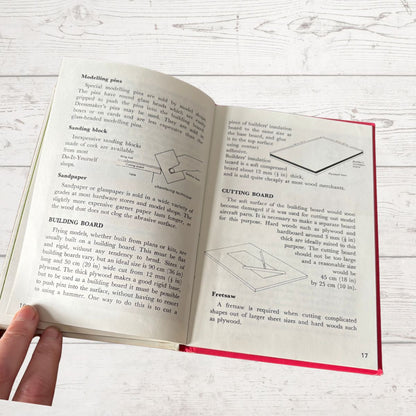 Open book with text and diagrams on a wooden surface