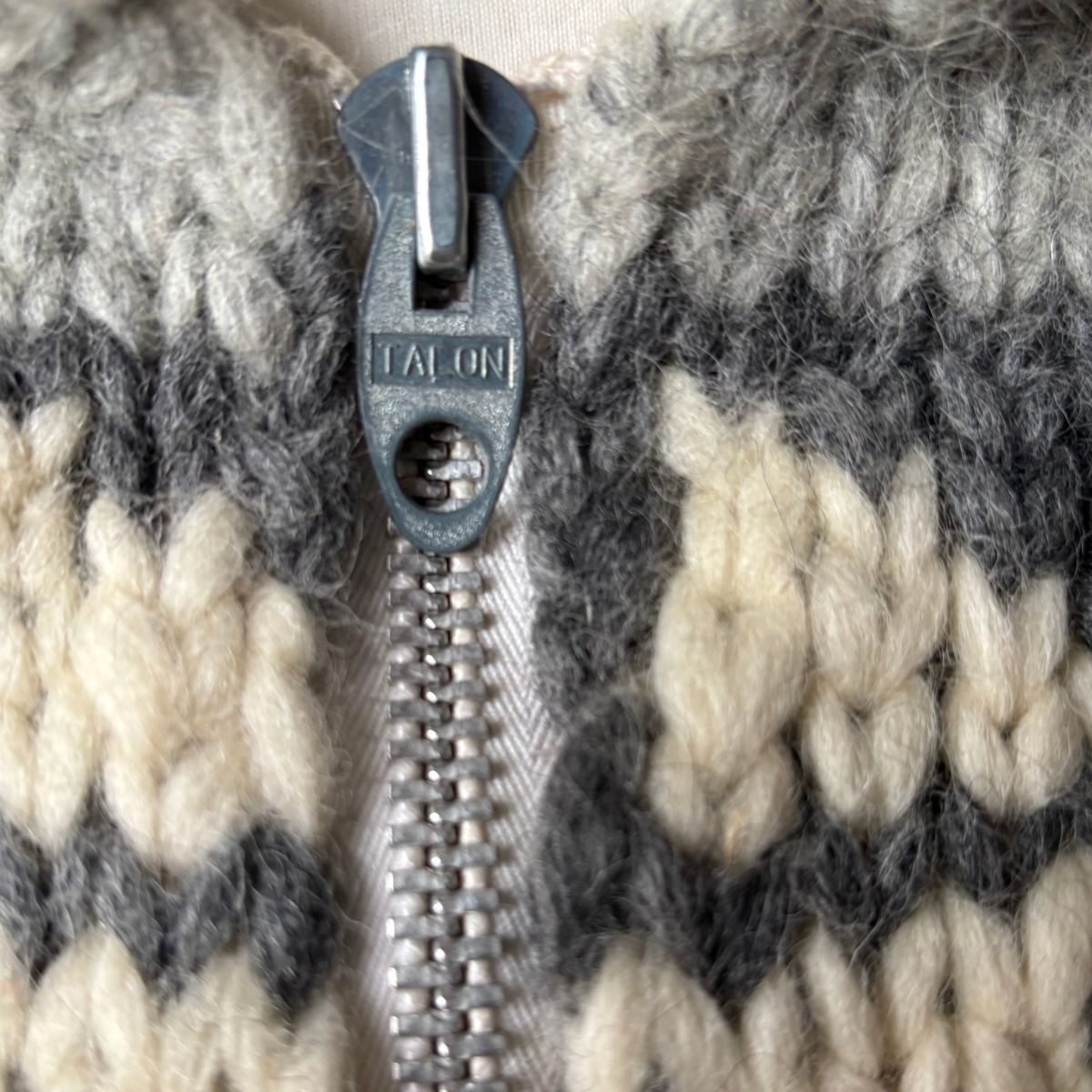 Close-up of a zipper on a textured fabric background