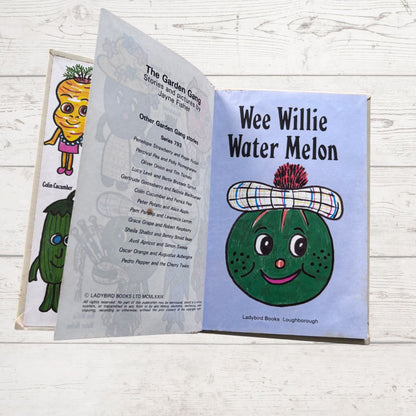 Open book showing 'Wee Willie Water Melon' character with Ladybird Books branding on a wooden surface.