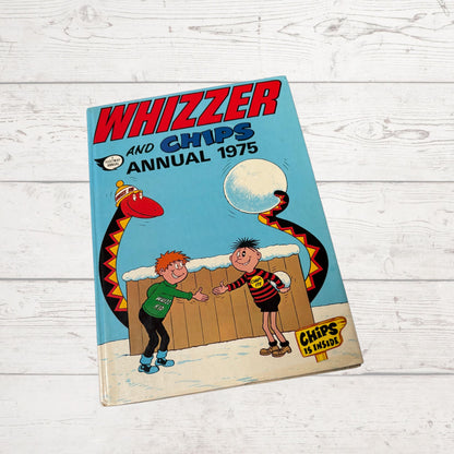 Vintage 'Whizzer and Chips Annual 1975' on a wooden surface