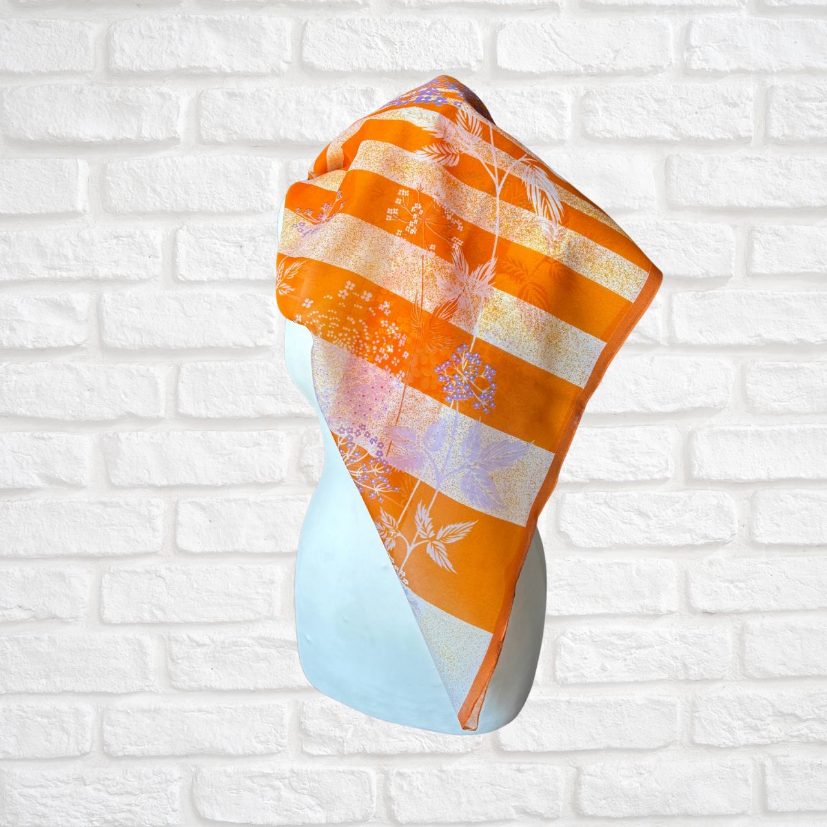Colourful scarf  on a white brick wall background