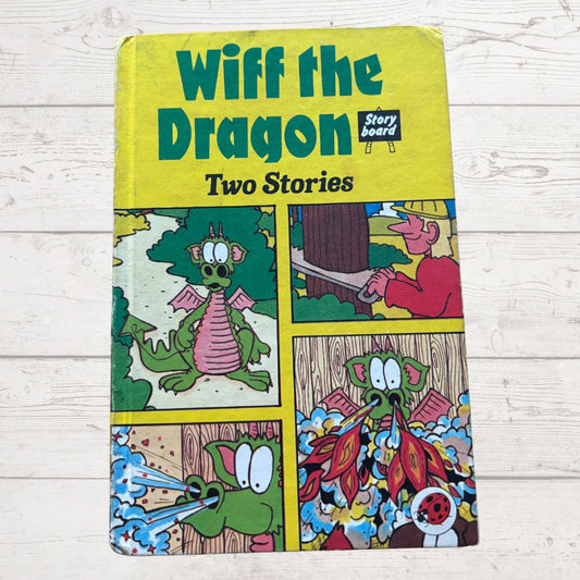Book titled 'Wiff the Dragon Two Stories' with colorful illustrations on a wooden surface