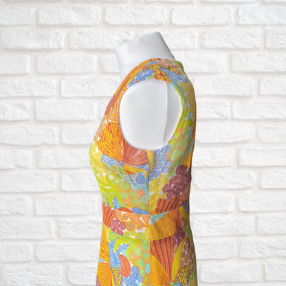 Colorful floral dress on a mannequin against a white brick wall background