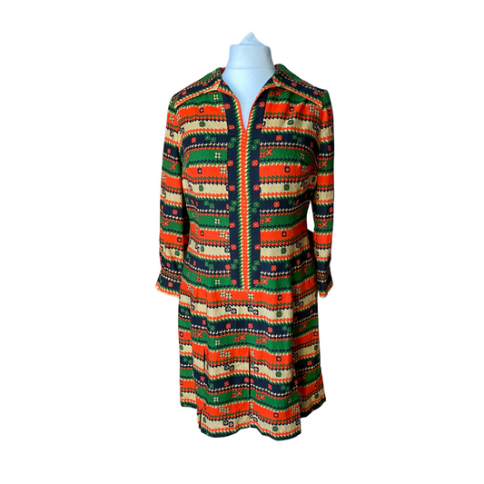 70s abstract floral print dress in red, green, black and beige with open dagger collar and pleated skirt. 