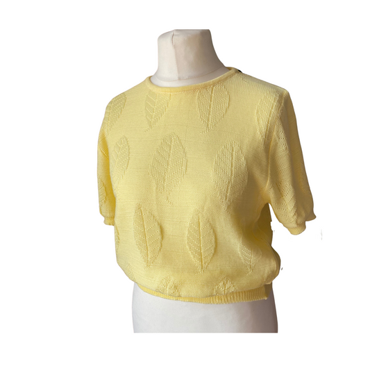 Short sleeved yellow 80s jumper with round neck and puffed sleeves. Knit is embossed  with a leaf print 