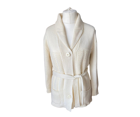 Cream shawl collar 1970s cardigan with button fastening and matching belt.