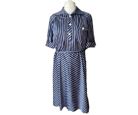 A navy blue and white vintage shirt waisted dress with large white buttons and a belt 